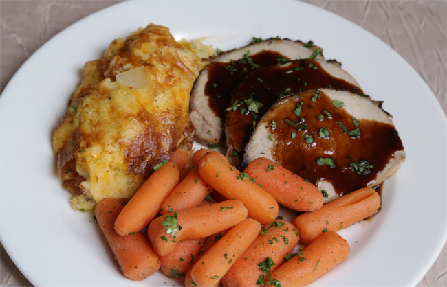 Herb Crusted Pork Loin with Twice Baked Potato Casserole and Buttered Baby Carrots